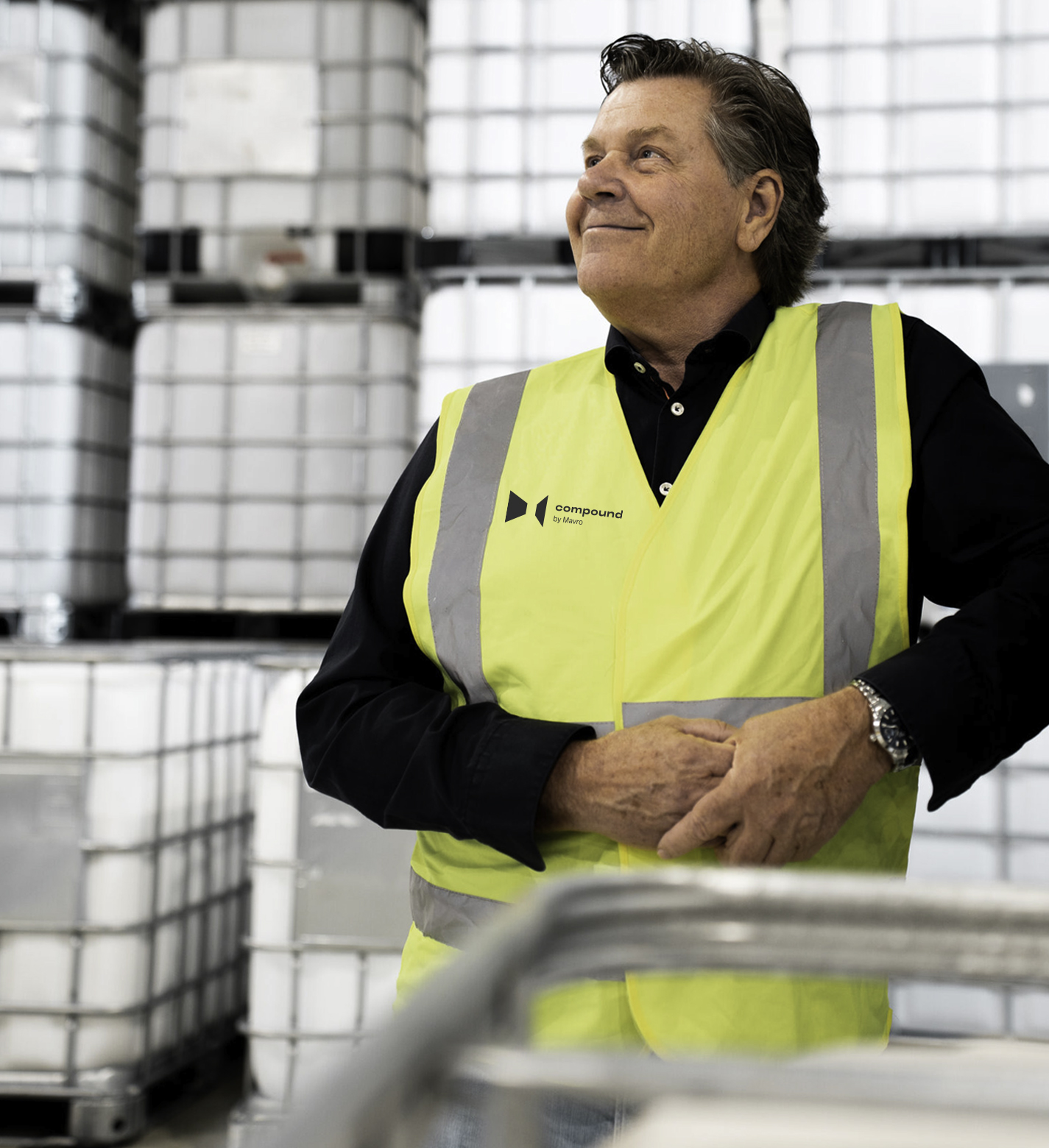 A proud account manager looks at operating machines in the factory